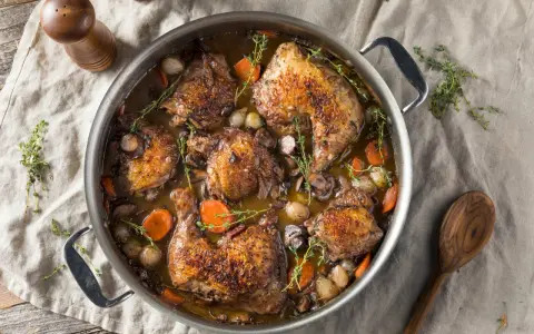 Herzhaftes Coq au Vin Rezept Original: Hähnchenteile schmoren in Rotwein mit Karotten, Zwiebeln und Pilzen. Ein Klassiker!