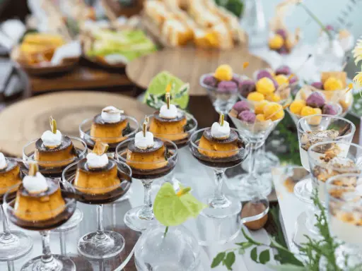 Köstliches Dessertbuffet für eine sommerparty essen 20 personen: Cremige Puddings, bunte Kugeln und süße Leckereien in Gläsern.